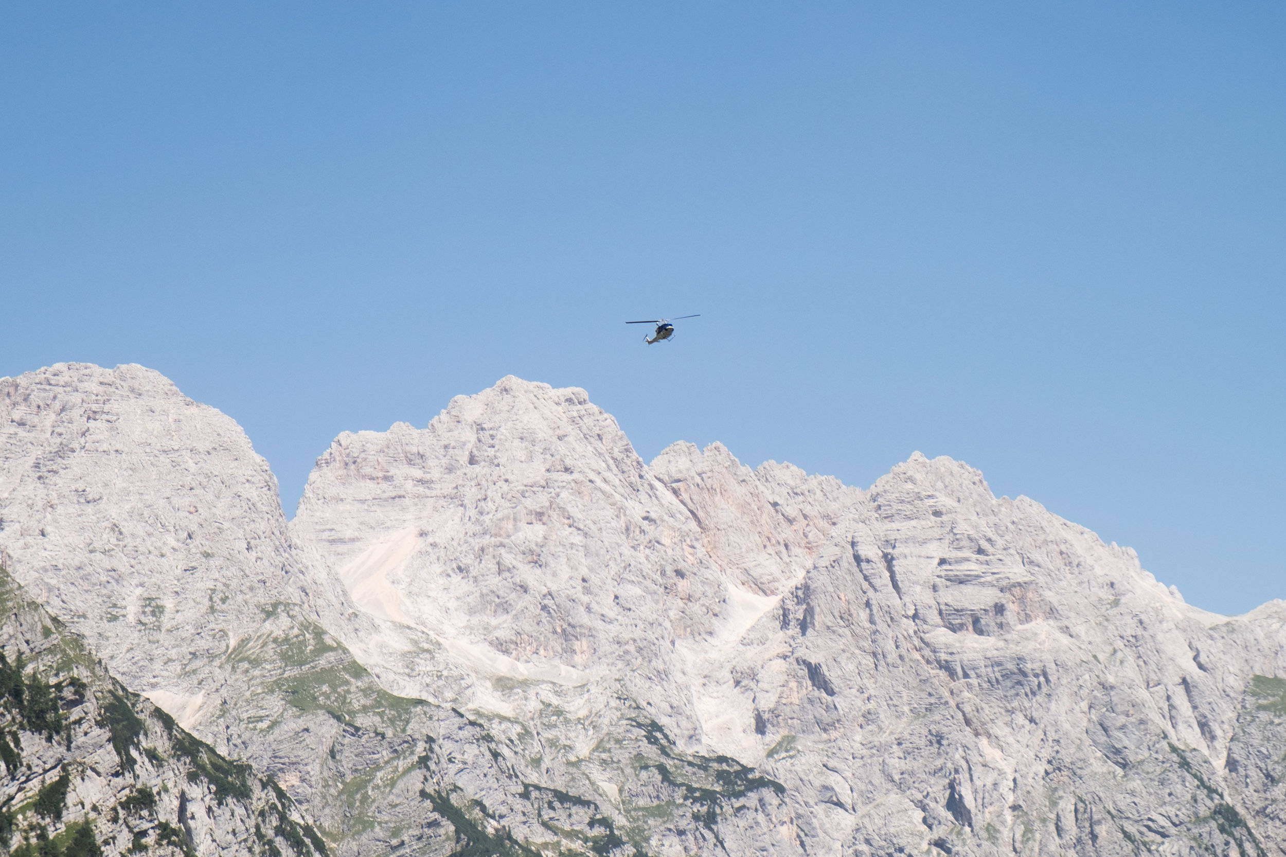 A rescue team flies in to assist another climber.