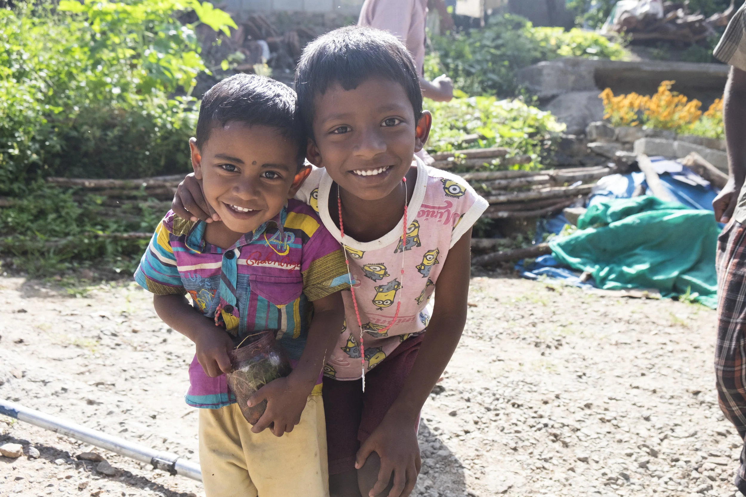 Two children come to say hello as we walk through their village.