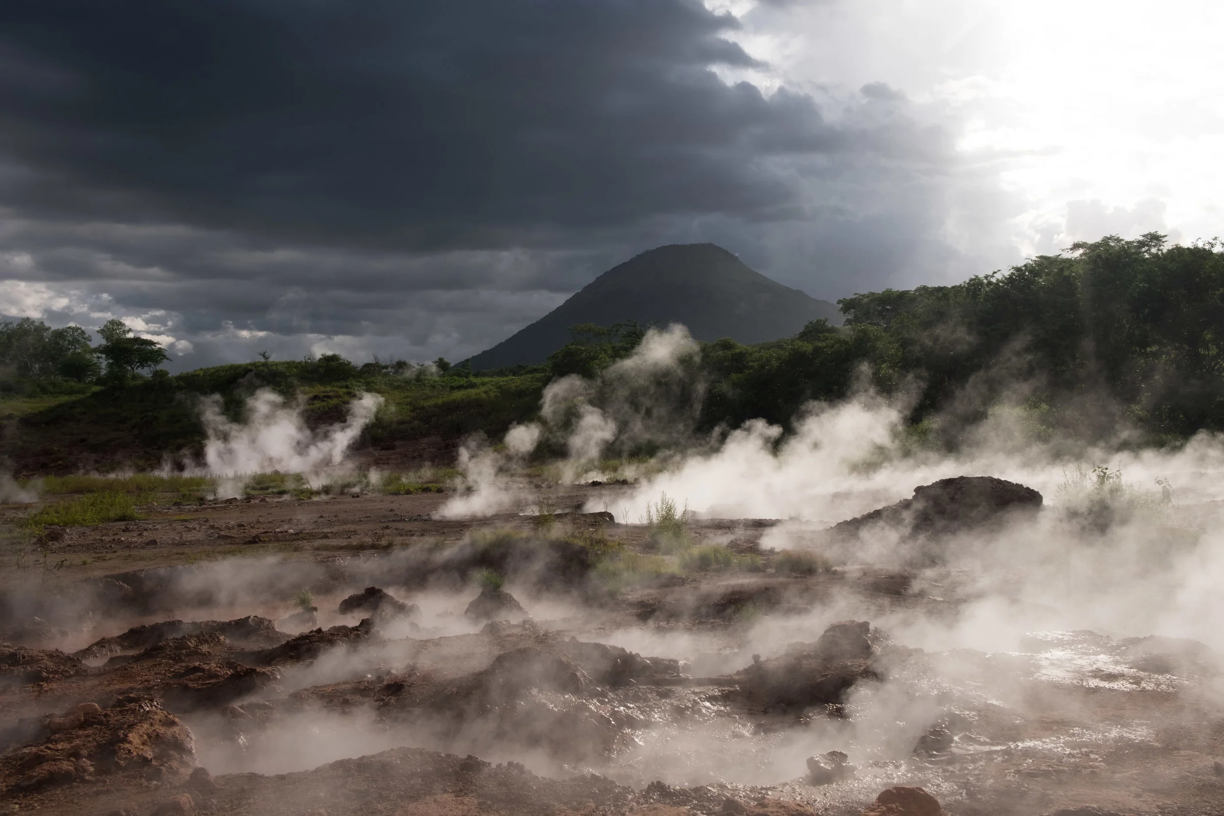 Steam rises through boiling mud at the foot of Santa Clara volcano.