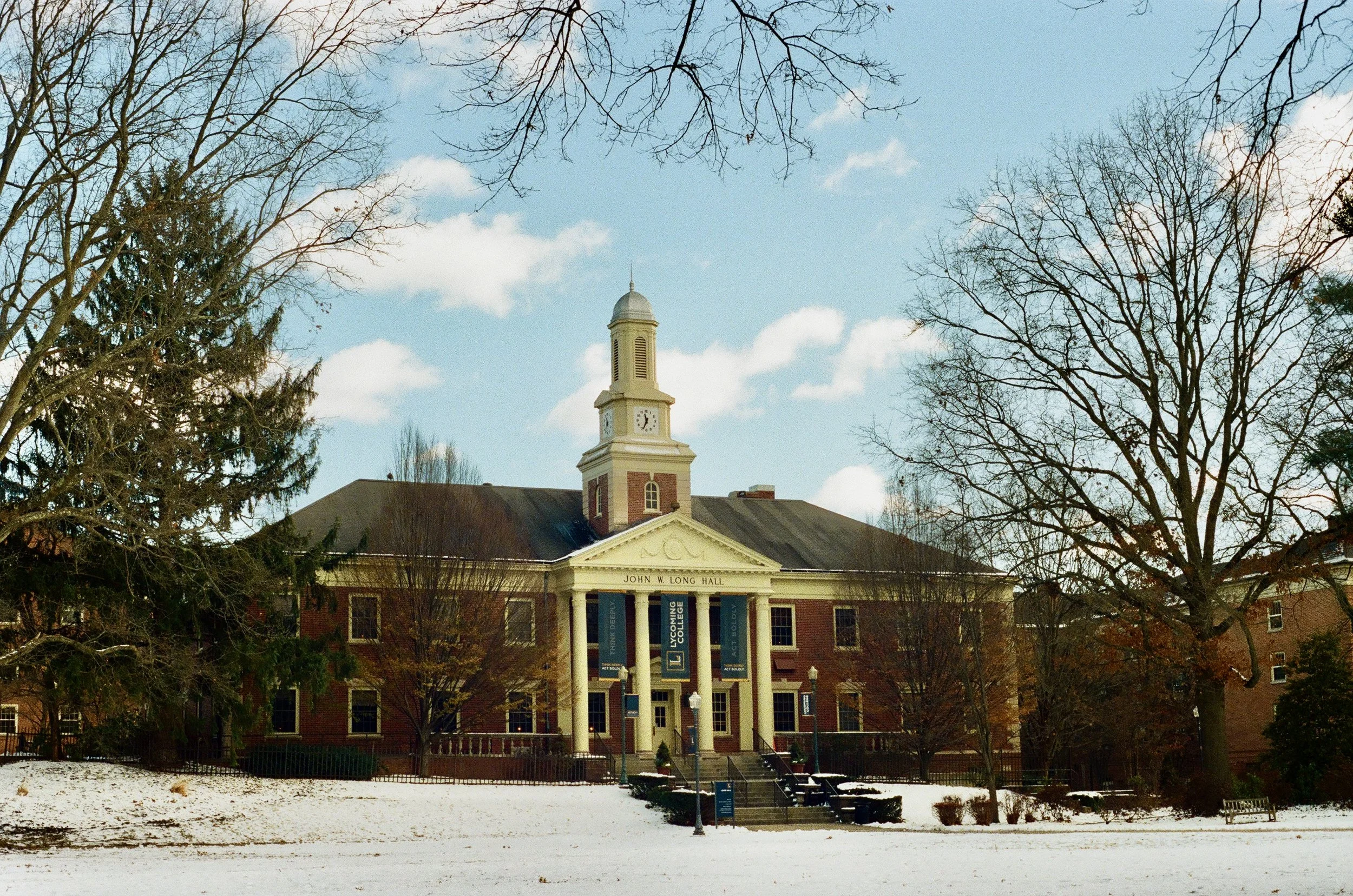 Campus administration building on a winter day. Snowy quad in the foreground.
