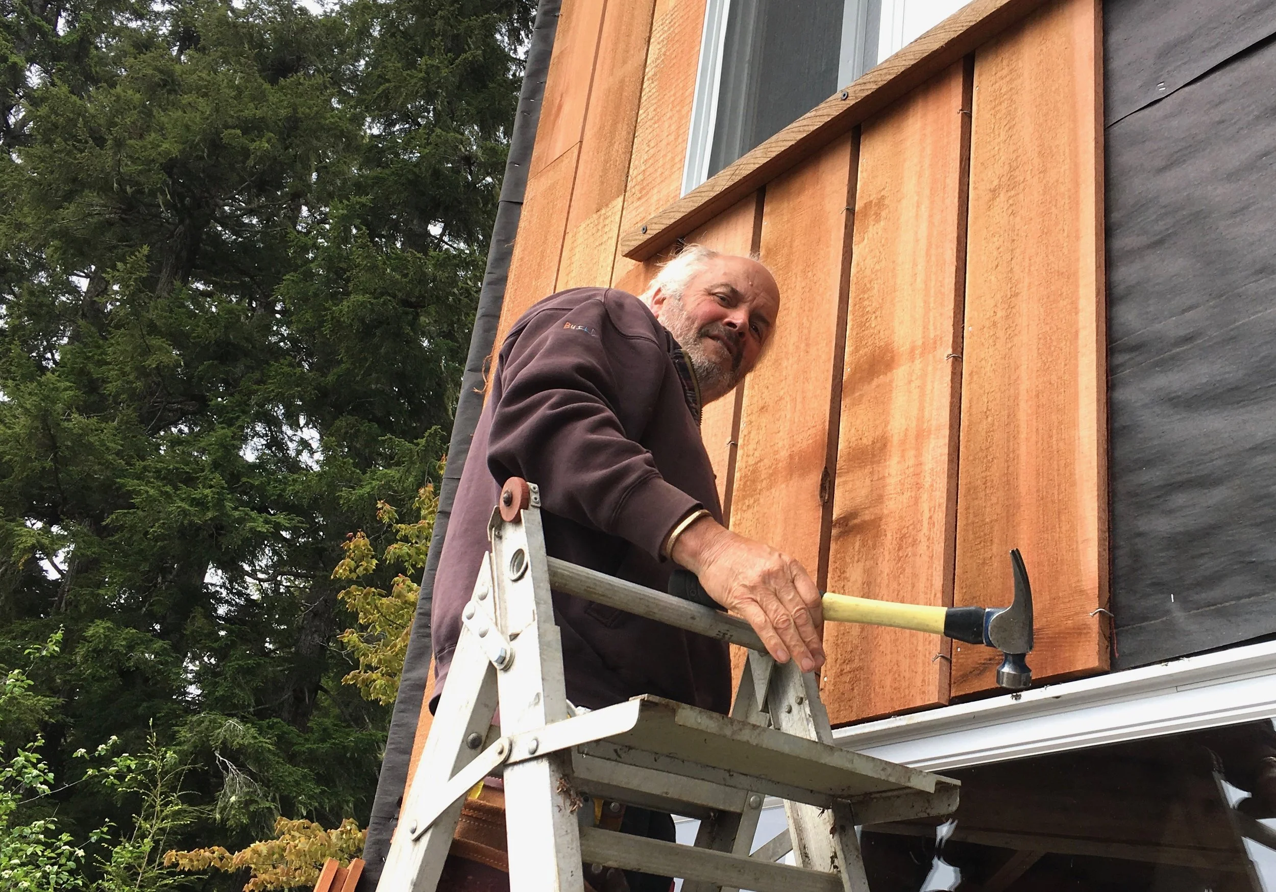 Phil installing new siding.