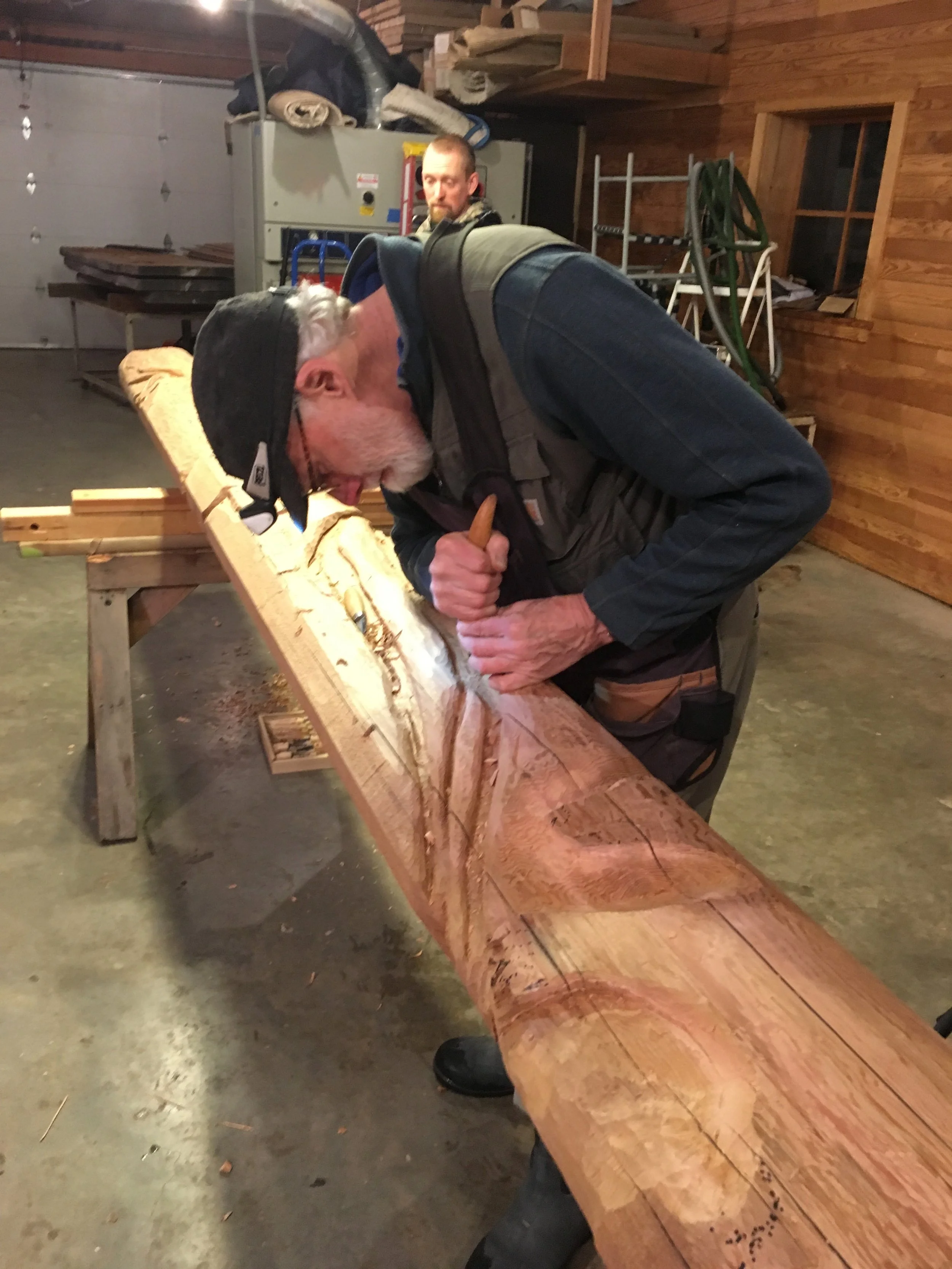 Richard Merrill carving rot pockets in his cedar rendition of a SE Alaskan hemlock snag, true to form.