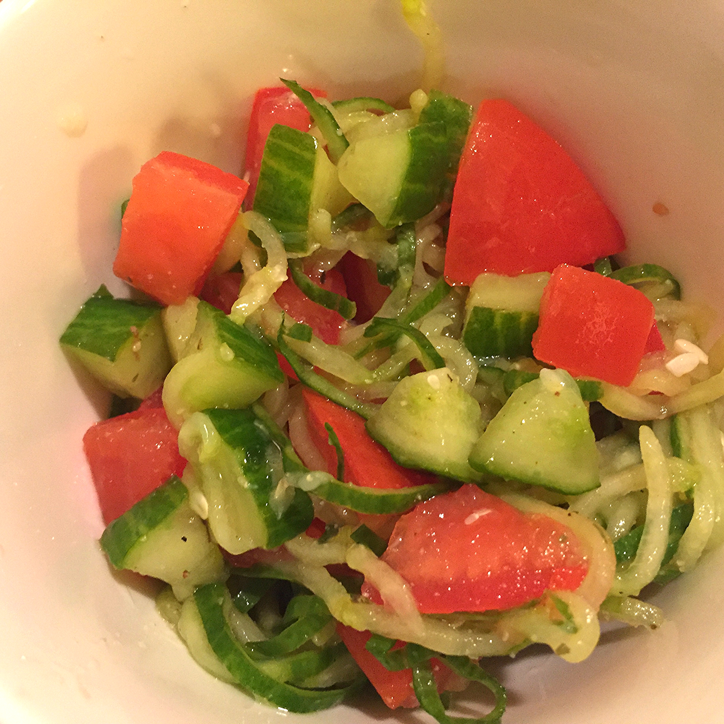 Spaghetti-like cucumber with lemon and tomatoes