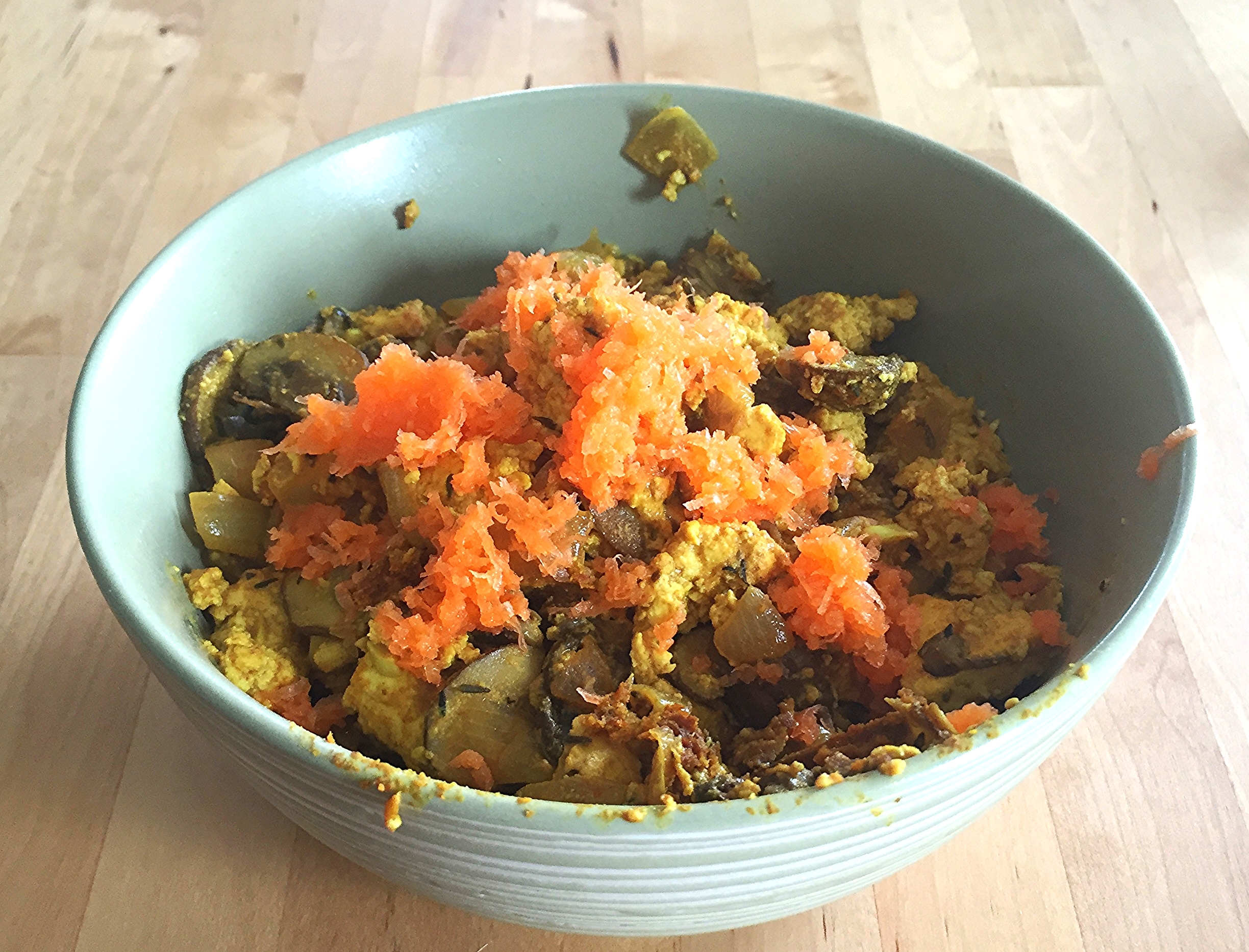 Scrambled tofu with cremini mushrooms, onions and shredded carrots