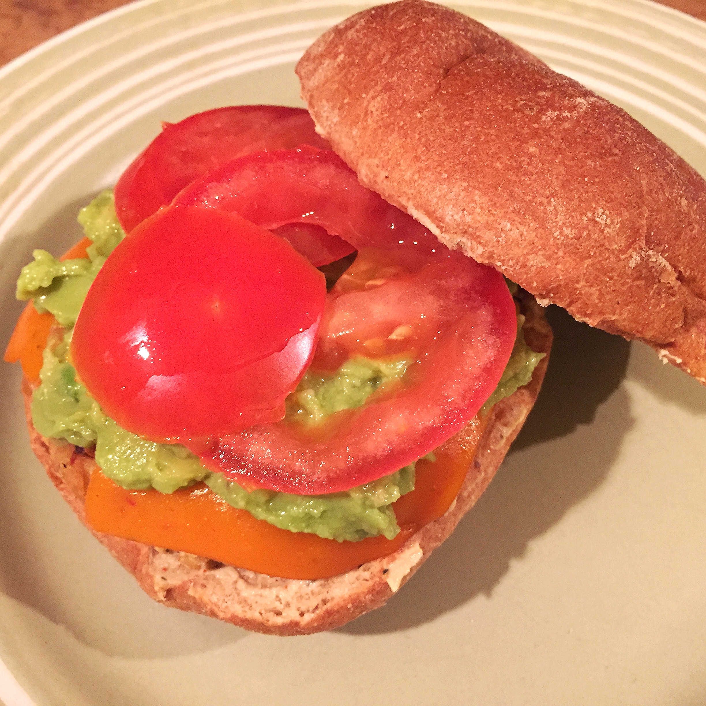 White bean and red lentil burger topped with vegan condiments