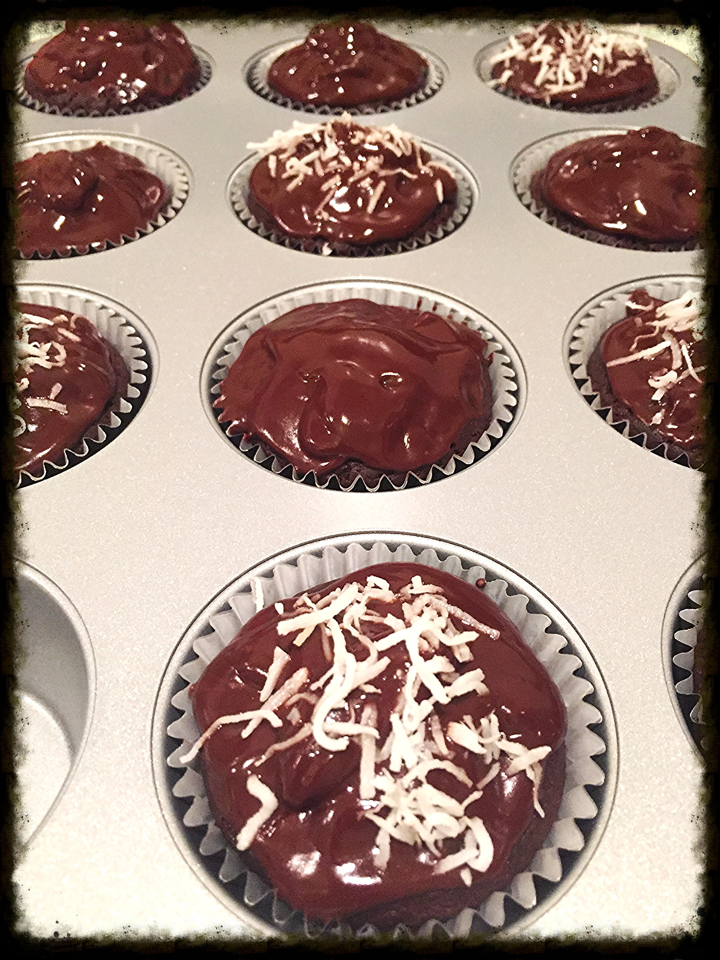 Vegan chocolate cupcakes topped with coconut sprinkles