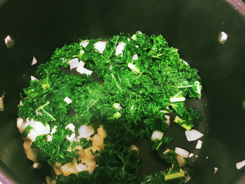 Stir frying the onions, garlic and kale