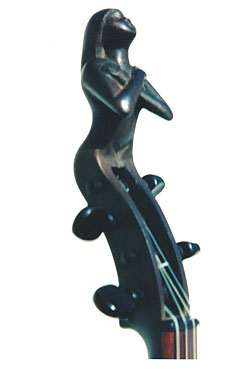 FIGUREHEAD A Peghead carving for a violin, hand carved from Hawaiian Ohia wood.