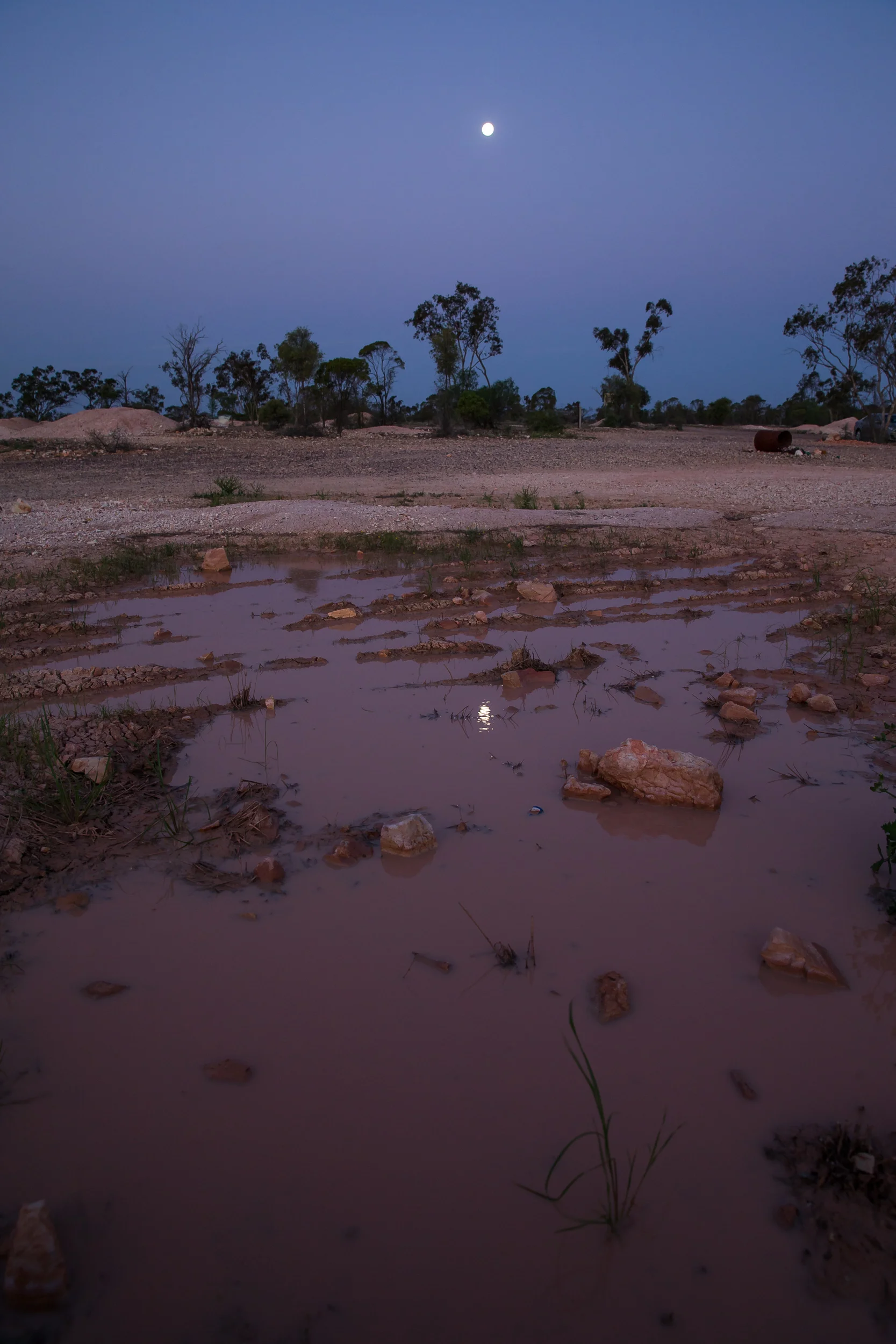 The full moon reflected in some mud pools at Lightning Ridge in the opal fields