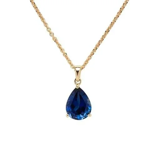 Close-up of Midnight Sky Gold Sapphire Pendant Necklace highlighting the rich sapphire stone, gold setting, and delicate pendant details.