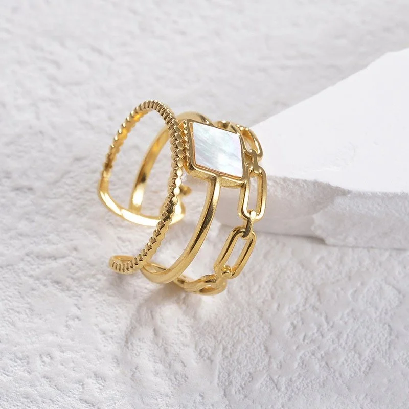 Square shaped mother of pearl solitaire set in polished gold.