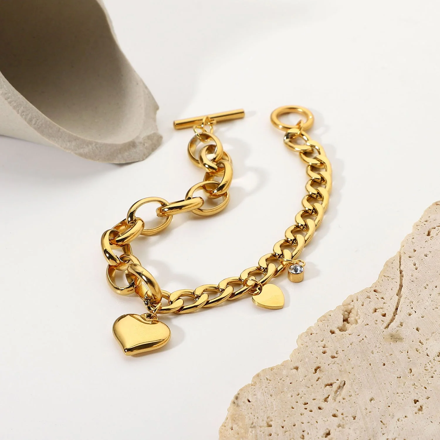 Amour gold polished bracelet with charms.