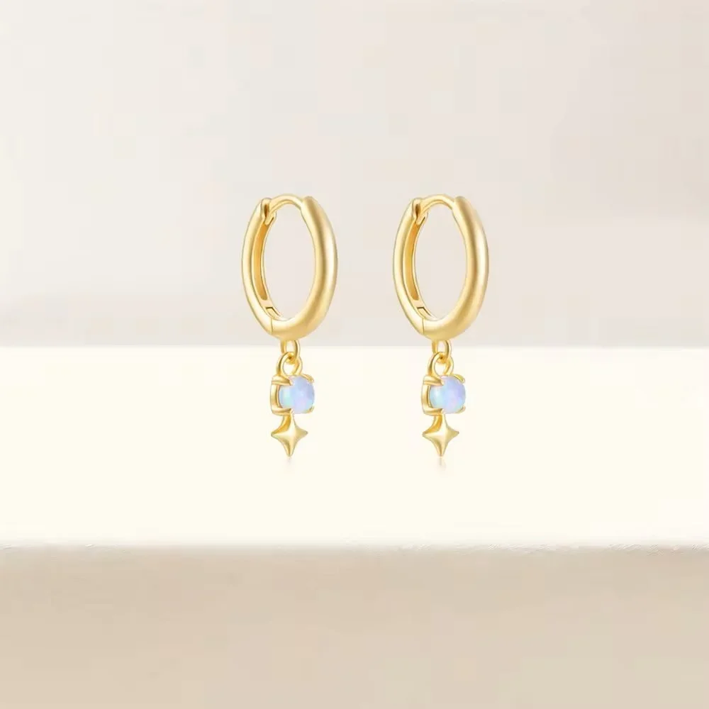 Stardust Gold Opal Huggie Earrings worn on model, showcasing an elegant and feminine gold jewelry look perfect for everyday wear.