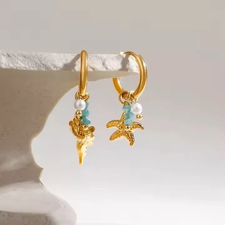 Ocean Air Gold Marine Charm Hoop Earrings hanging, showcasing a coastal-inspired gold jewelry style perfect for everyday wear.
