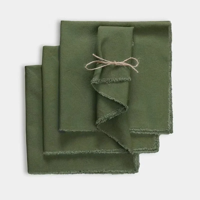 Forest green cotton linen napkin set of four with soft fringe edges, reusable cloth dinner napkins for holiday gatherings, everyday meals, and elegant table settings.