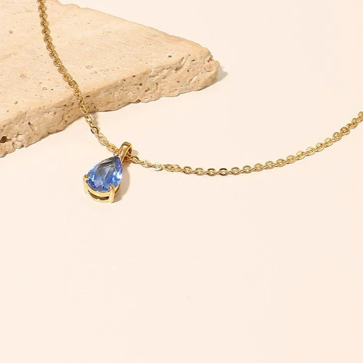 Close-up of Gold Arctic Blue Gemstone Pendant Necklace highlighting the icy blue gemstone detail, gold setting, and refined pendant craftsmanship.