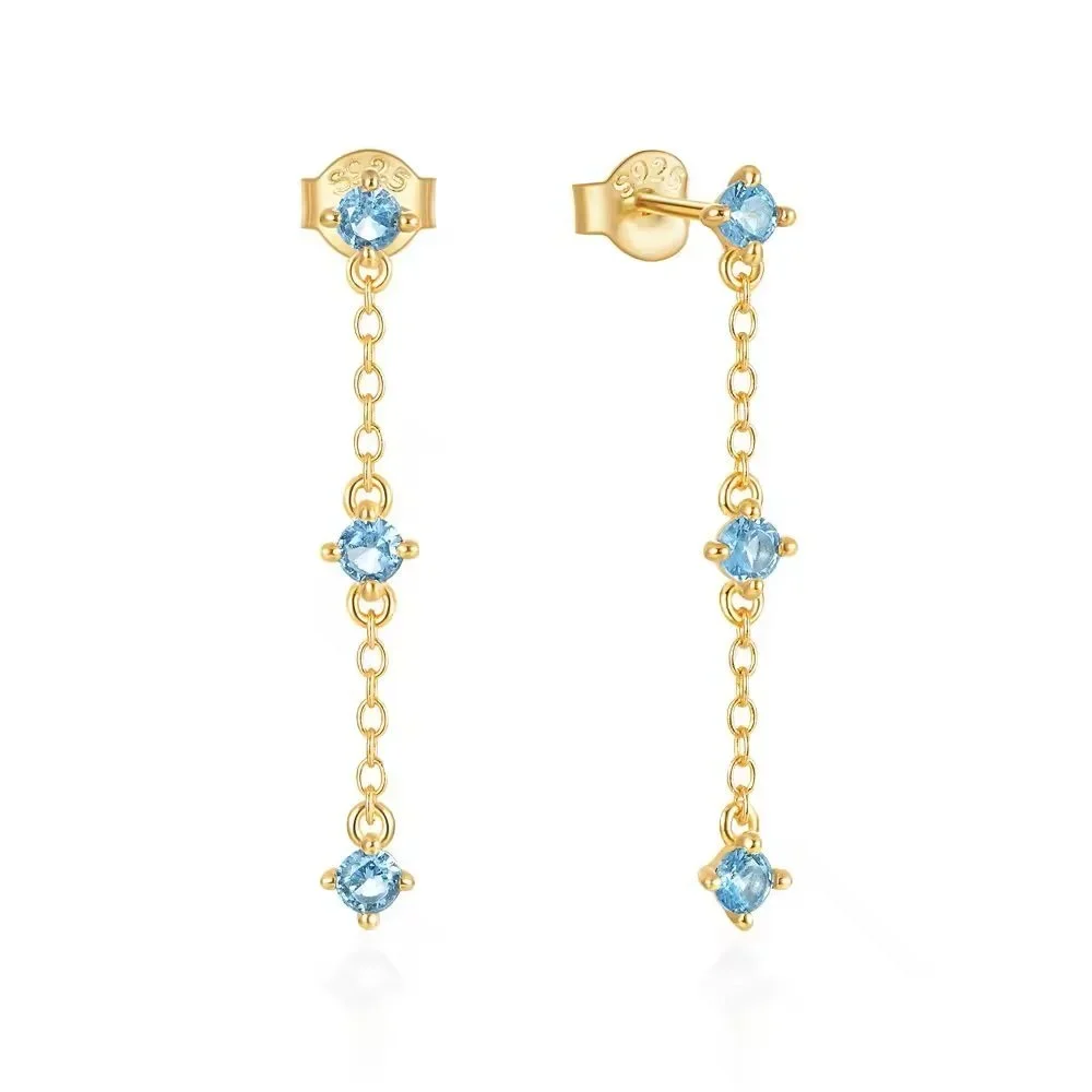 Aria Blue CZ Gold Drop Earrings featuring sparkling blue cubic zirconia stones with a polished gold setting and elegant drop earring design.