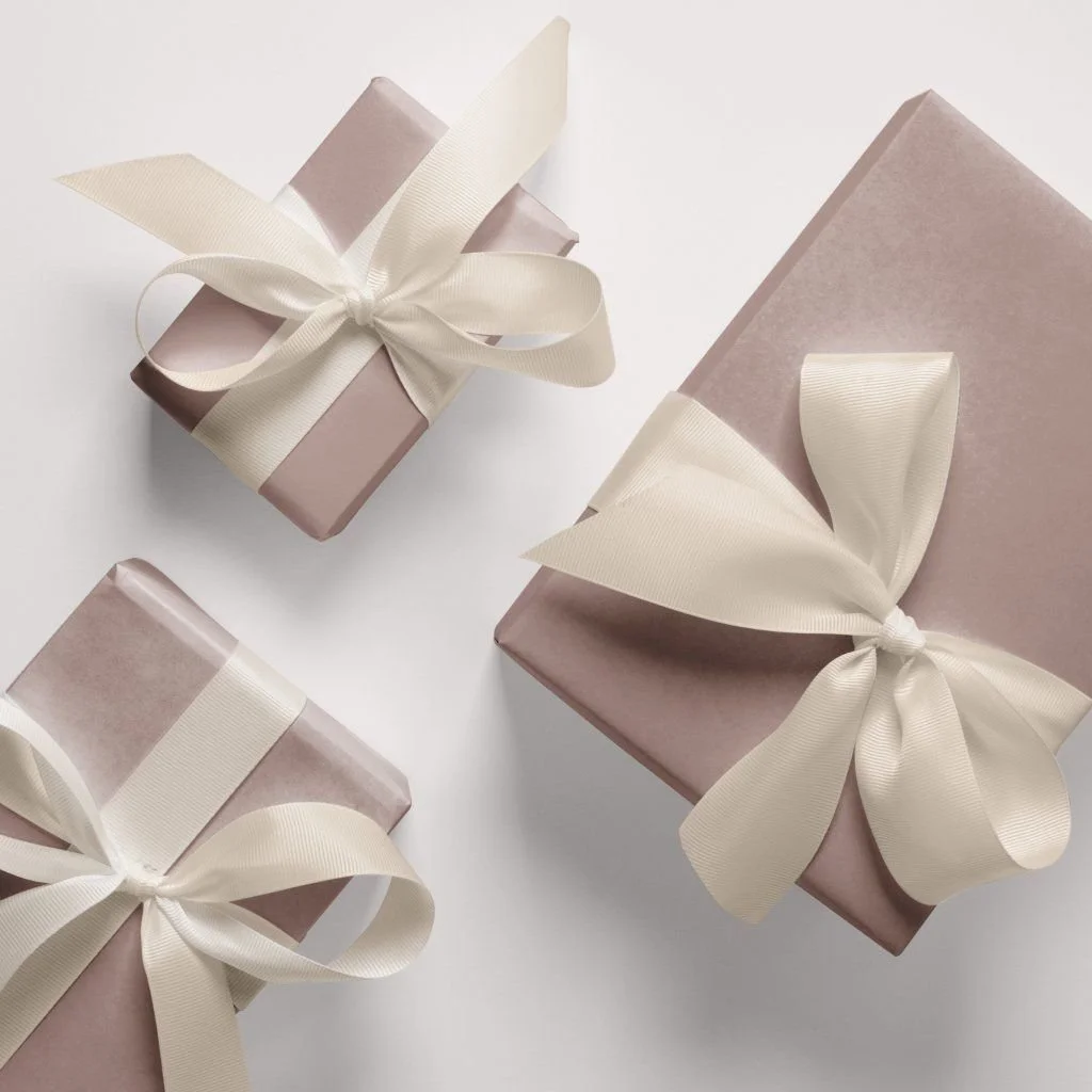 Gifts wrapped in premium gift wrap and ribbon.
