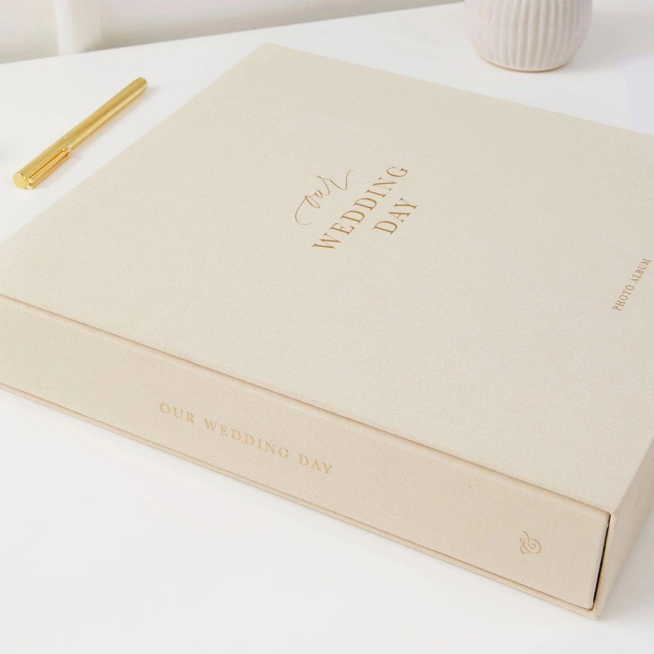 Personalized ivory wedding photo album with premium fabric cover and timeless heirloom design.