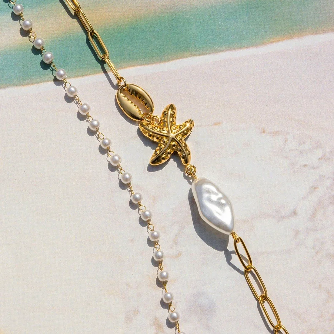 Close-up of Gold Pearl Starfish Double Strand Bracelet highlighting the freshwater pearl details, starfish charm, and elegant layered bracelet design.