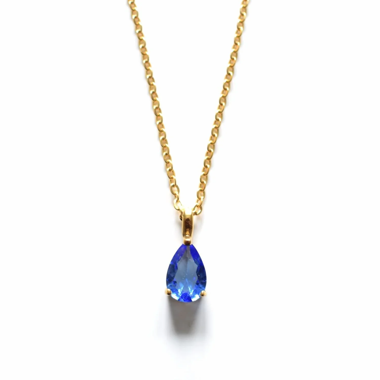 Gold Arctic Blue Gemstone Pendant Necklace featuring a vibrant blue gemstone pendant with a polished gold chain and elegant minimalist design.