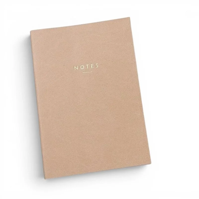 Tan leather notebook with lined pages for notes and journaling.