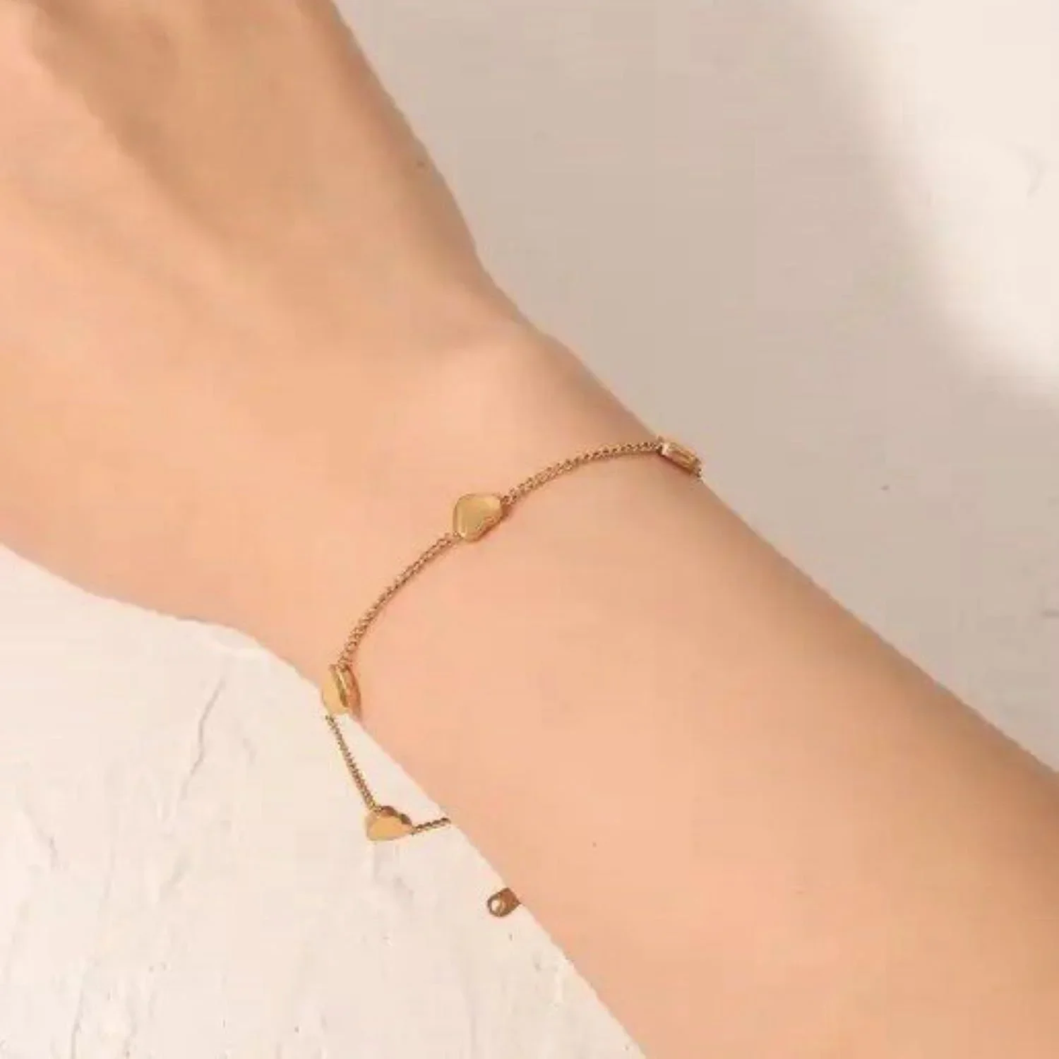 Hartley Gold Floating Heart Bracelet worn on wrist, showcasing a romantic and feminine gold jewelry style perfect for everyday wear.