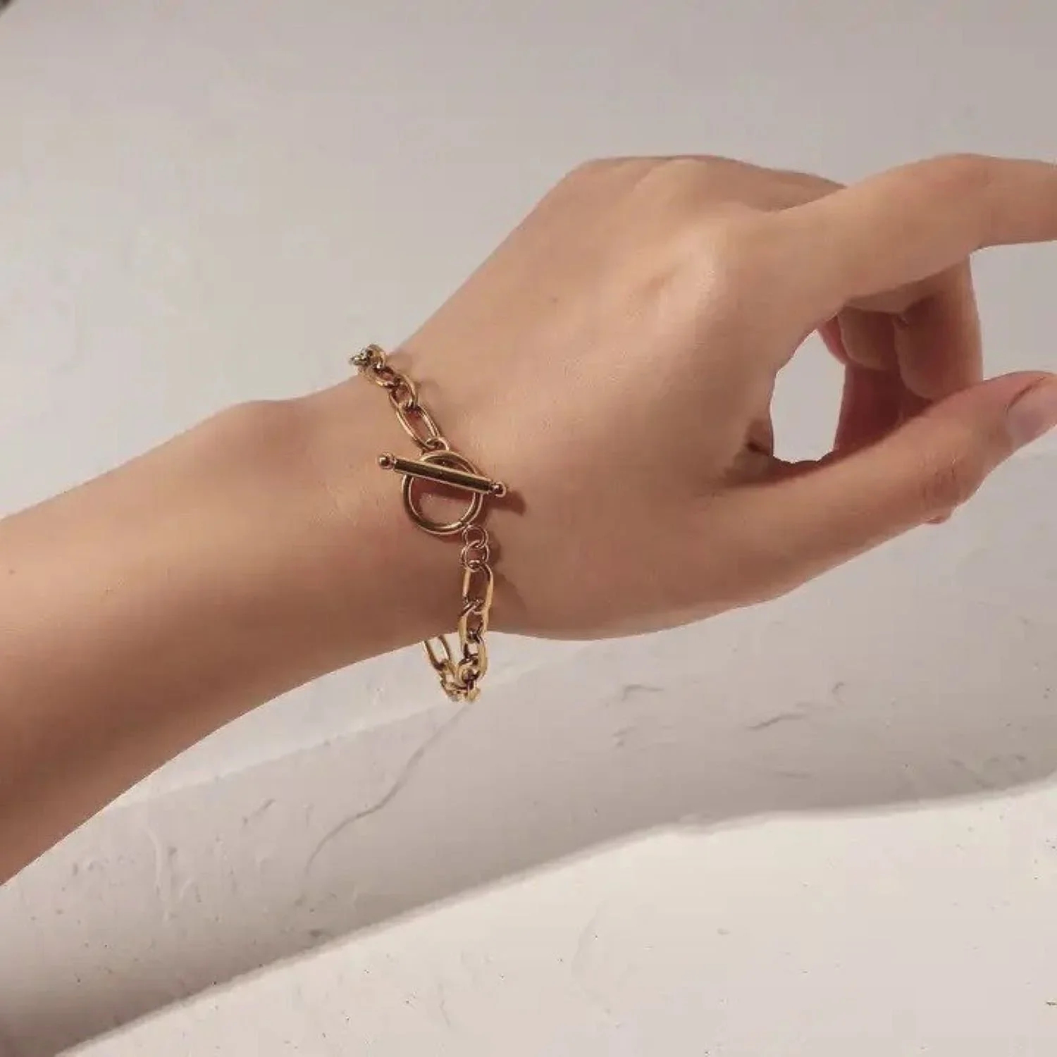 Close-up of Parker Gold Chain Link Toggle Bracelet highlighting the interlocking chain links, smooth gold finish, and stylish toggle detail.