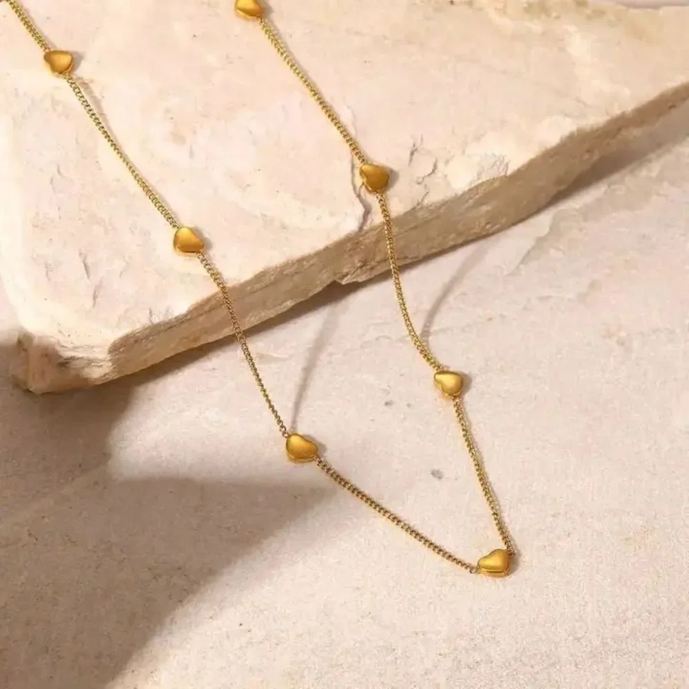 Close-up of Hartley Gold Floating Heart Necklace highlighting the heart pendant detail, fine gold chain, and refined jewelry craftsmanship.