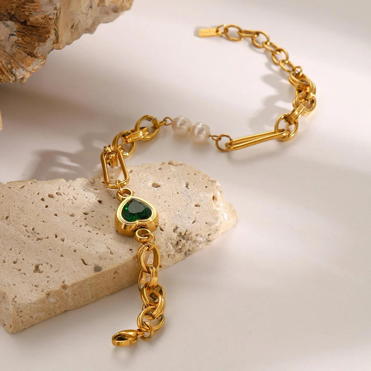 Gold emerald gemstone charm bracelet with cultured pearls.