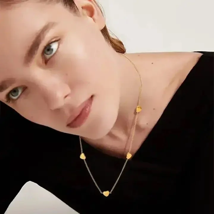 Hartley Gold Floating Heart Necklace worn on model, showcasing a romantic and feminine gold jewelry style perfect for everyday wear.