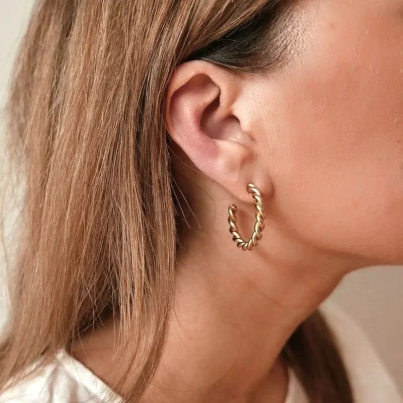 Twisted Rope Gold Hoop Earrings worn on model, showcasing a chic and timeless gold jewelry style perfect for everyday wear or special occasions.