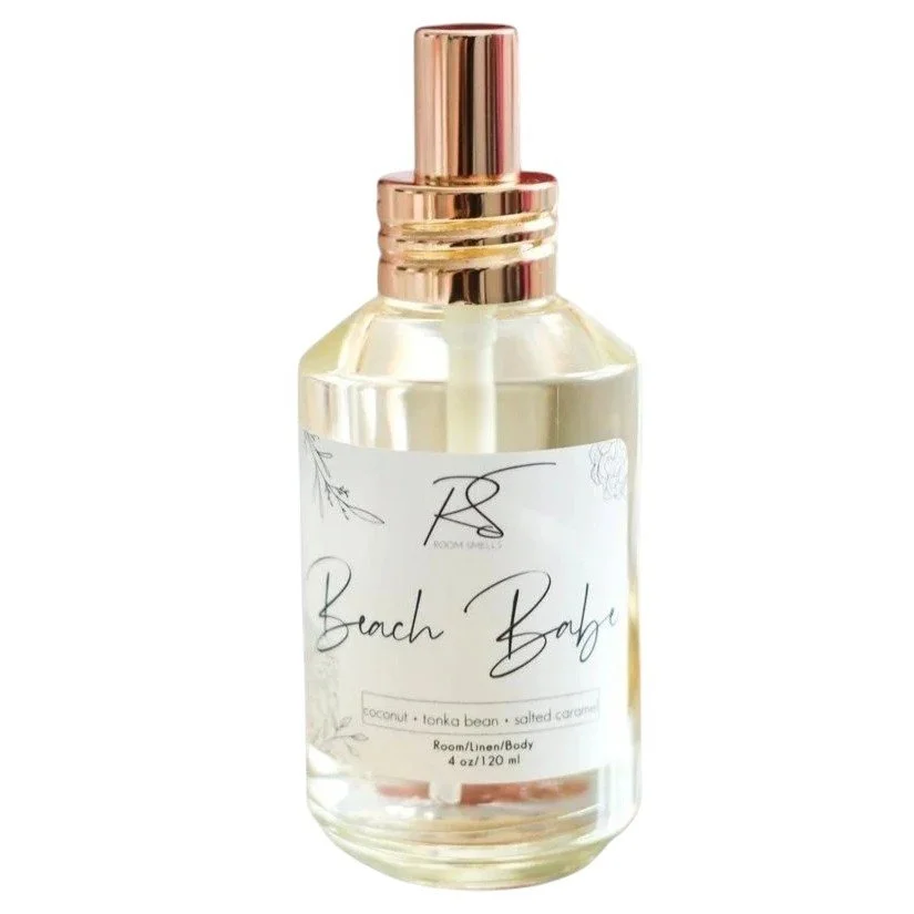 Beach Babe perfume in a clear glass bottle with coconut, tonka bean, and salted caramel fragrance notes.