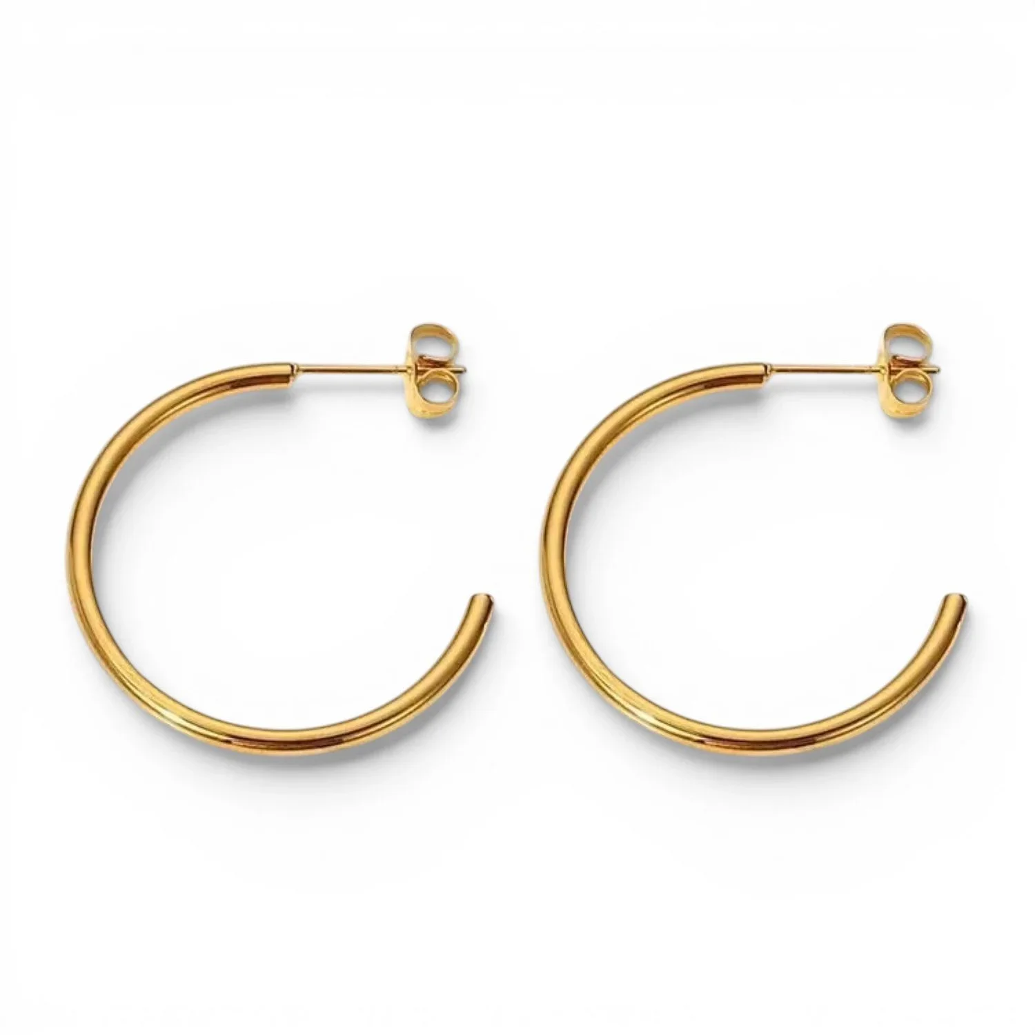 Close-up of Classic Gold Hoop Earrings highlighting the sleek gold finish, rounded hoop shape, and minimalist jewelry design.