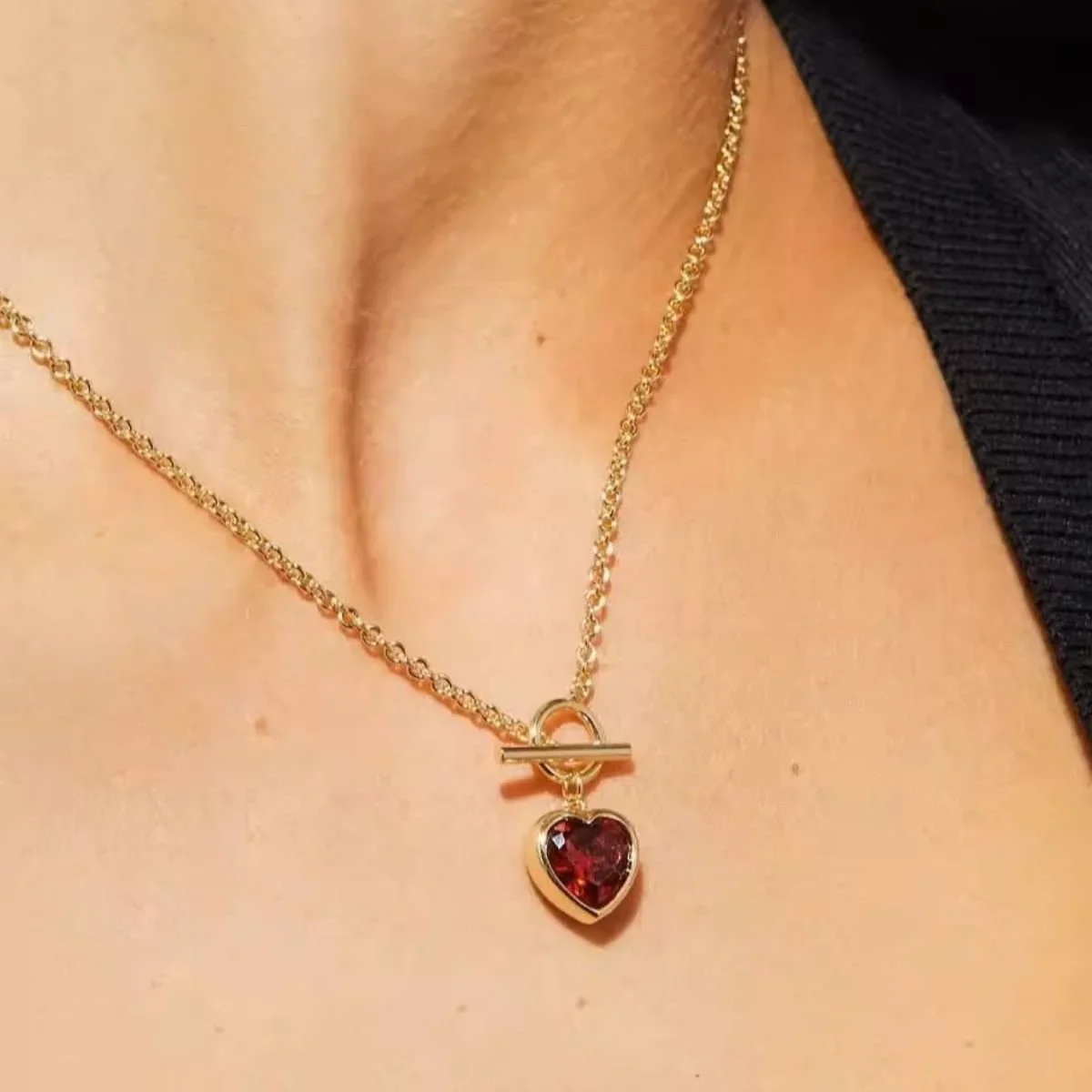 Love Me Gold Red Heart Pendant Toggle Necklace worn on model, showcasing a romantic and feminine gold jewelry style perfect for everyday wear or special occasions.