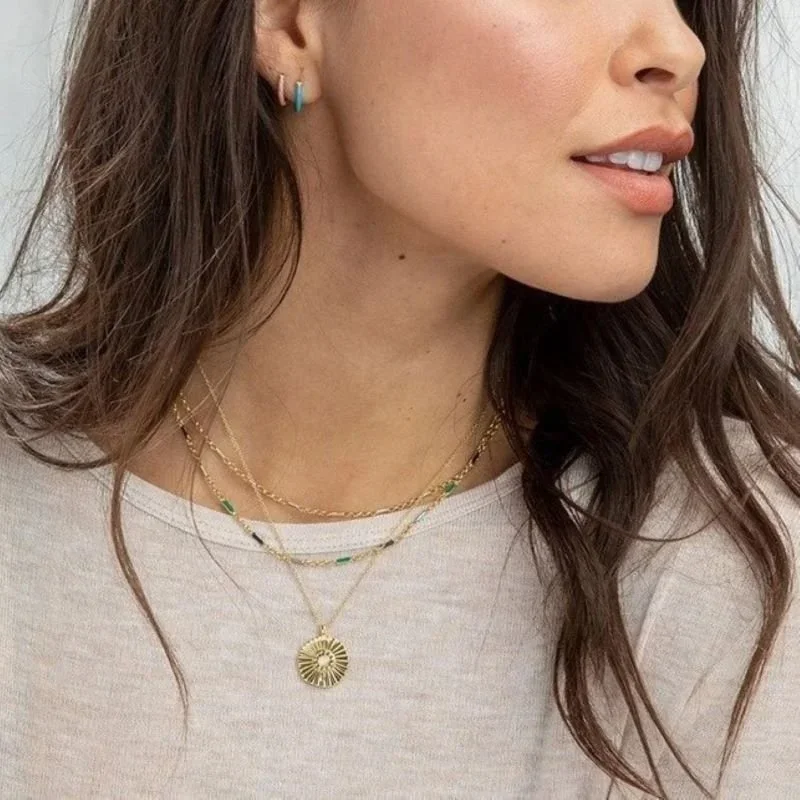 Close-up of Rising Sun Opal Coin Pendant Necklace highlighting the shimmering opal details, sun-inspired coin pendant, and delicate gold chain.