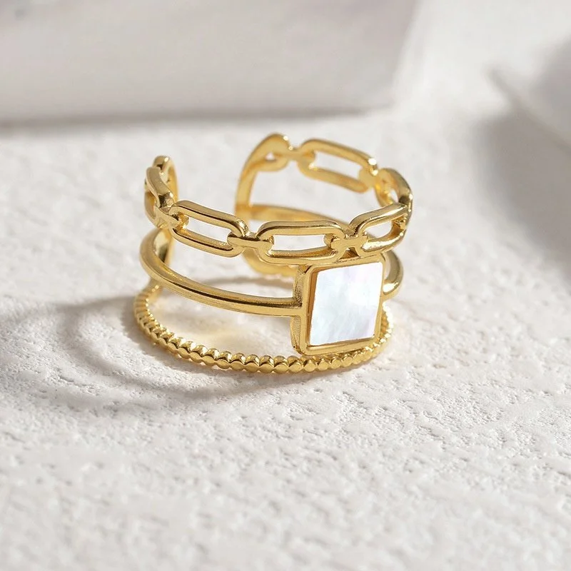 Chunk gold ring with mother of pearl gemstone with and adjustable closure.