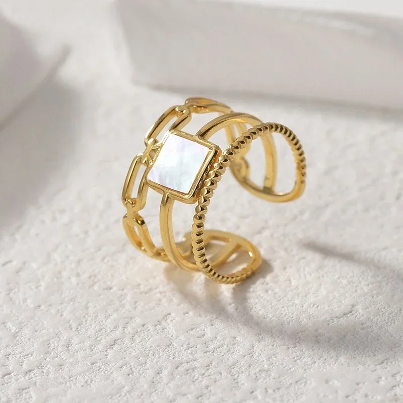 Close-up of Athena Adjustable Gold Solitaire Mother of Pearl Ring highlighting the iridescent pearl stone, gold setting, and adjustable ring design.