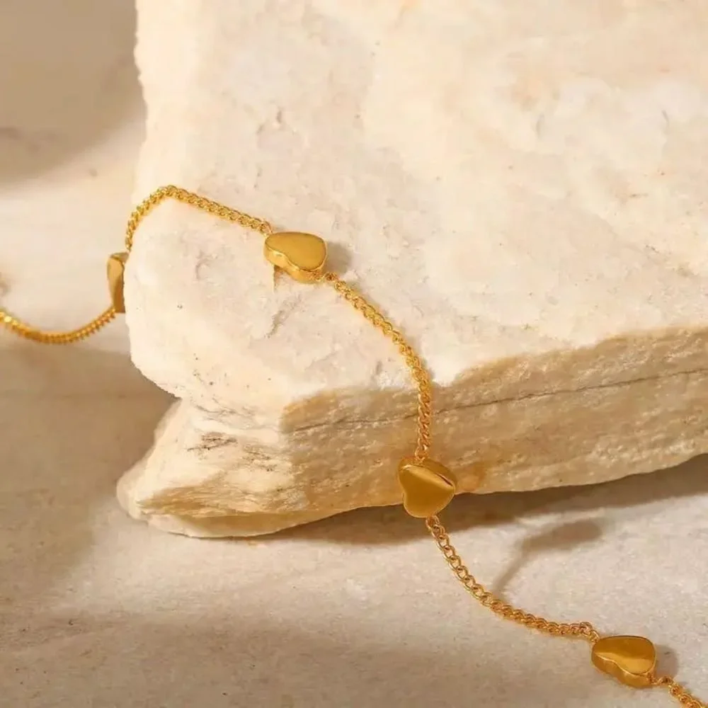Close-up of Hartley Gold Floating Heart Bracelet highlighting the heart charm detail, refined gold finish, and delicate bracelet craftsmanship.