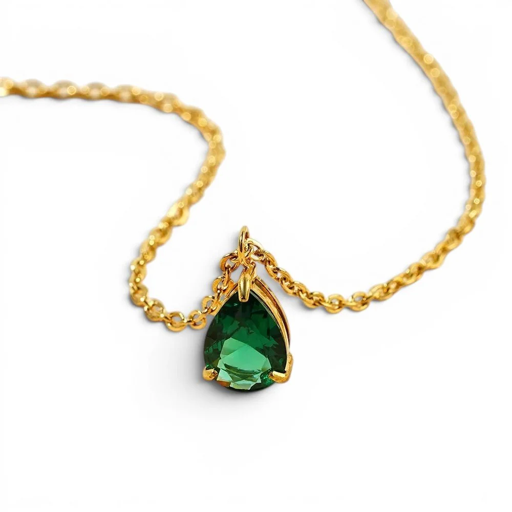 A classic and timeless emerald necklace set in a gold chain with an adjustable clasp closure.
