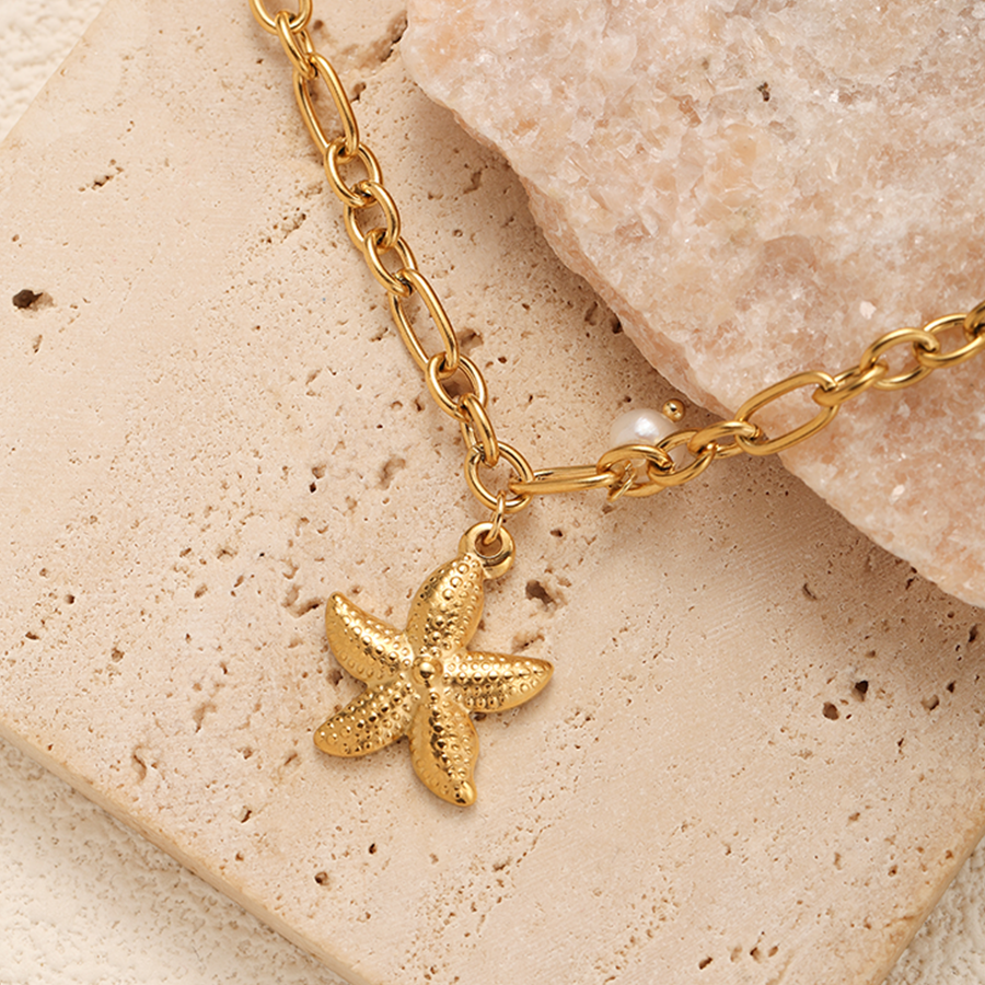 Close-up of Gold Pearl Starfish Pendant Necklace highlighting the pearl detail, starfish pendant design, and elegant gold chain.