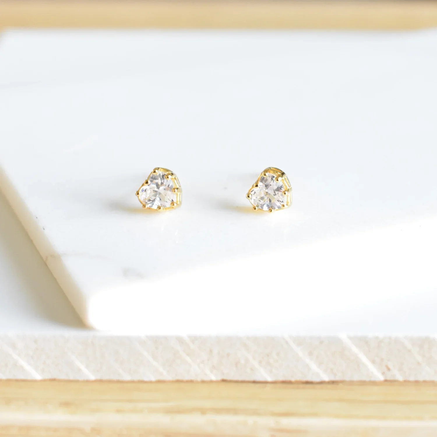 Close-up of True Love CZ Stud Earrings highlighting the shimmering cubic zirconia details, elegant setting, and delicate gold design.