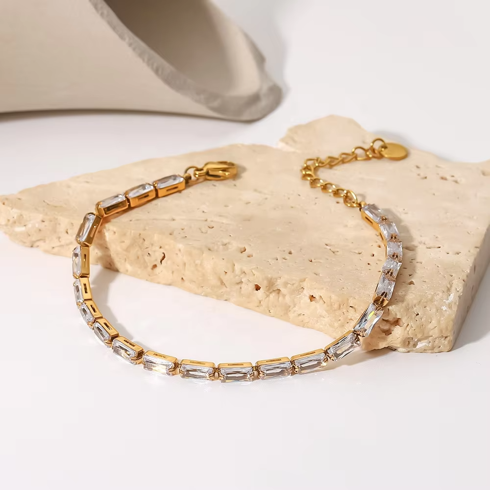 Gorgeous gold tennis bracelet with brilliant cubic zirconia's and adjustable clasp closure.