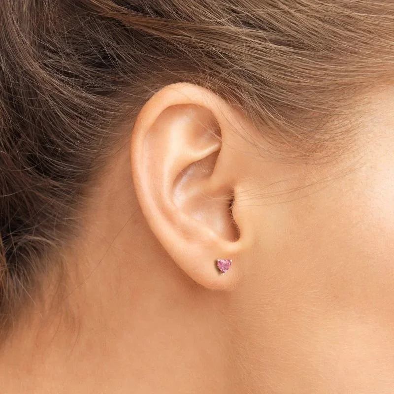 Passion Pink Heart Gold Stud Earrings worn on model, showcasing a playful and feminine jewelry style perfect for everyday wear or special occasions.