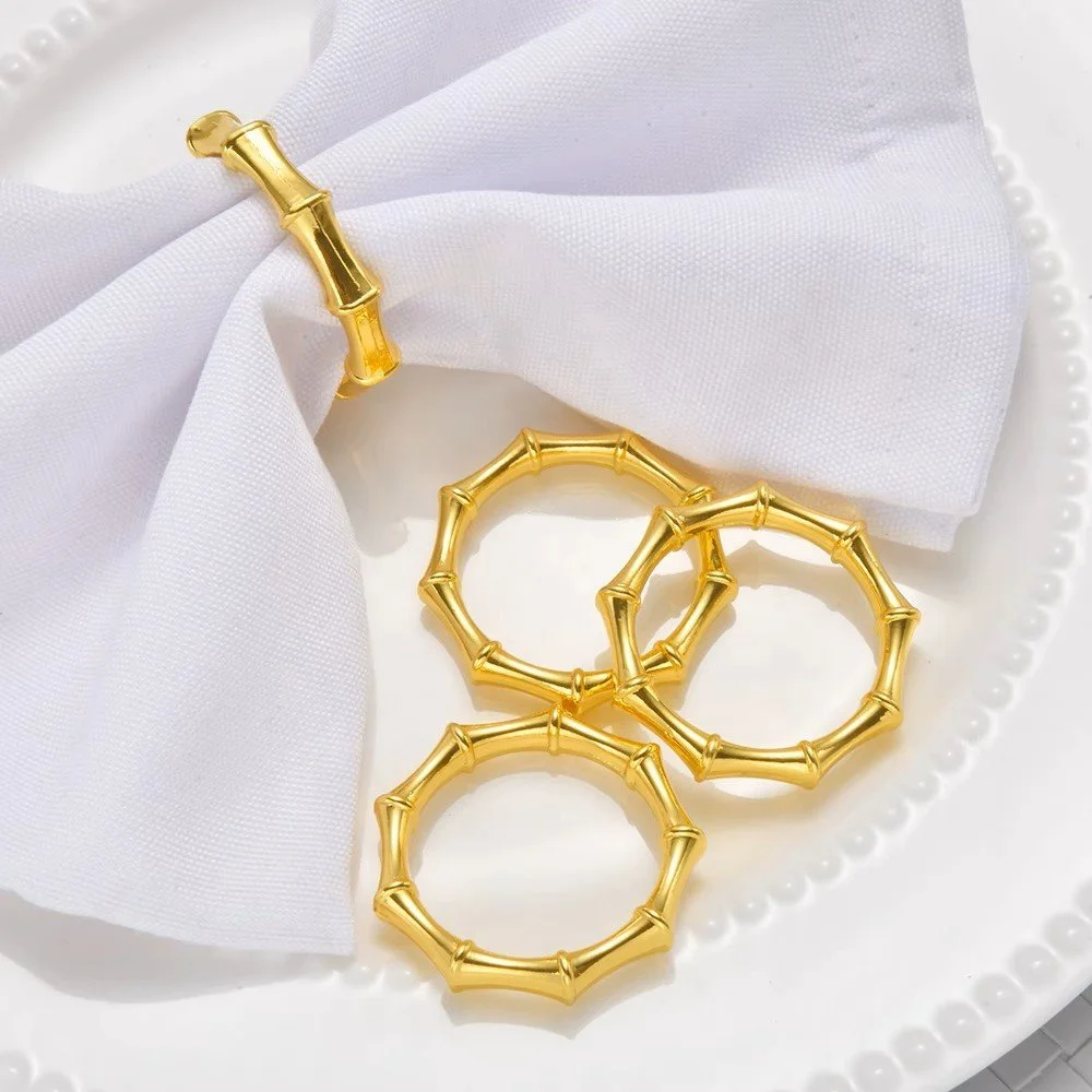 Bali gold napkin rings set of four with a bamboo-inspired textured design for elegant table settings.