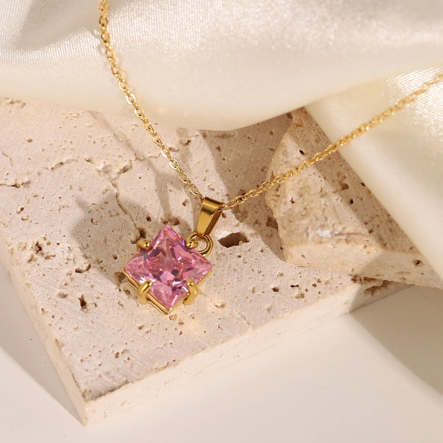 Close-up of Pink CZ Gold Pendant Necklace highlighting the vibrant pink cubic zirconia stone, gold setting, and delicate pendant details.