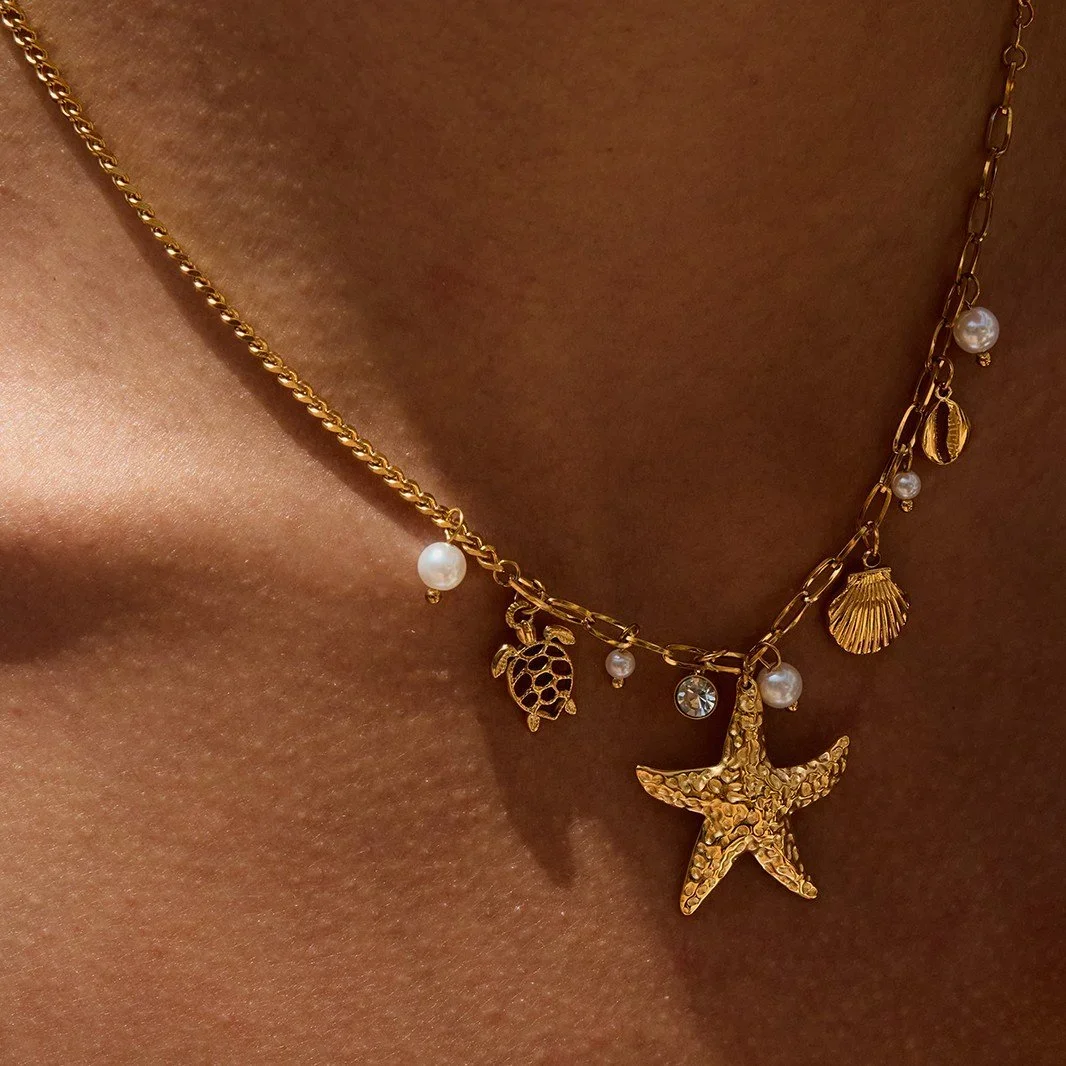 Gold Pearl Starfish Charm Necklace worn on model, showcasing a beach-inspired jewelry style perfect for everyday wear and vacation looks.