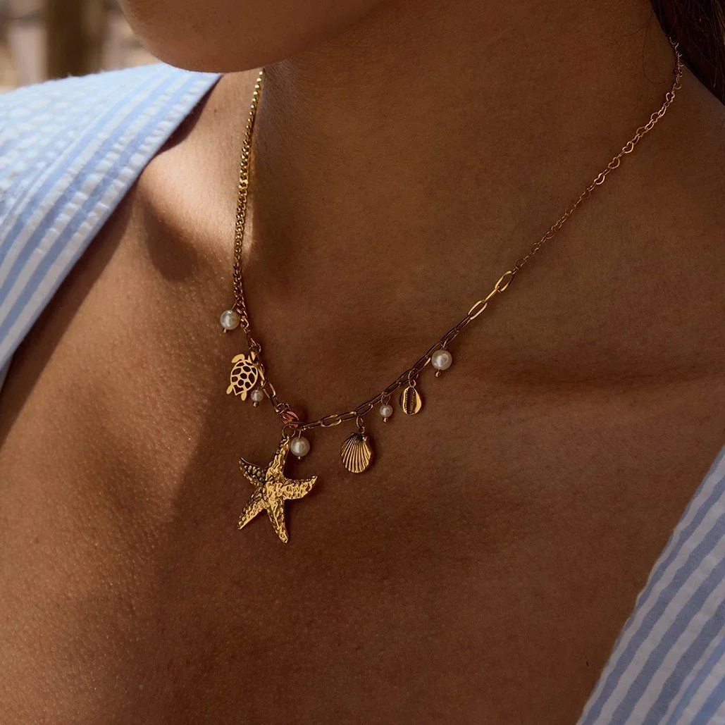Gold Pearl Starfish Charm Necklace for women, a coastal-inspired gold and pearl jewelry gift perfect for birthdays, summer occasions, and special moments.