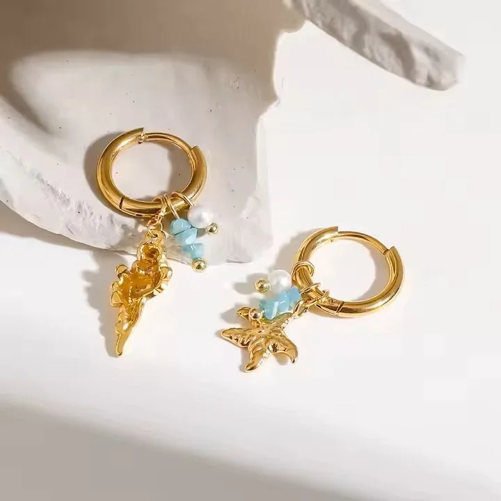 Close-up of Ocean Air Gold Marine Charm Hoop Earrings highlighting the detailed marine charms, textured accents, and elegant gold design.