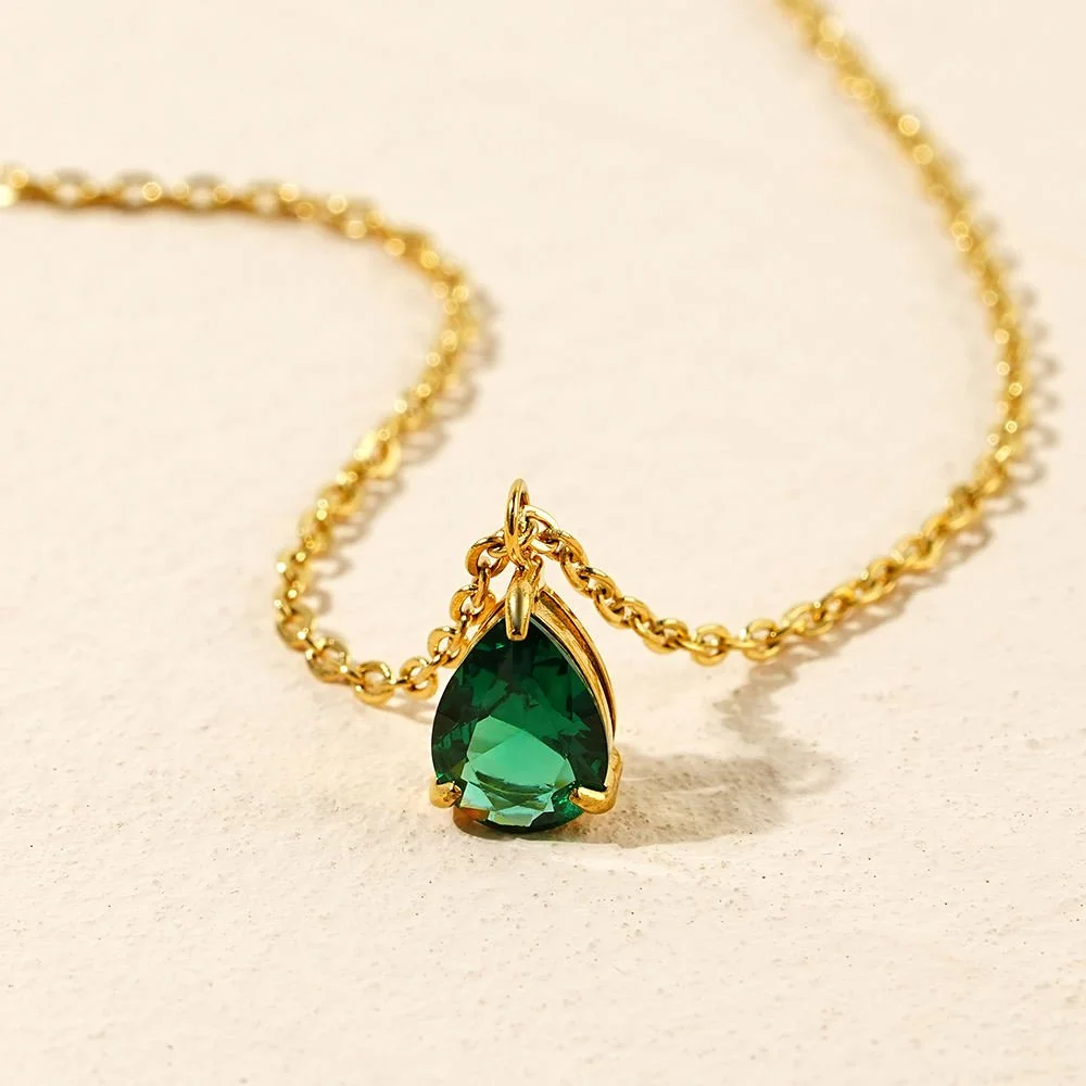 A classic and timeless emerald necklace set in a gold chain with an adjustable clasp closure.